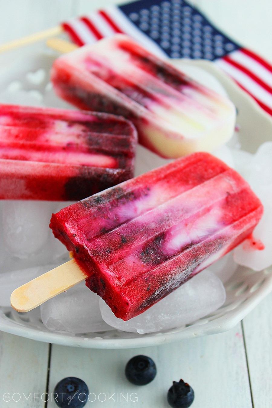 Firecracker Berry Frozen Yogurt Pops – Yogurt, strawberries and blueberries make these patriotic pops a guilt-free treat! | thecomfortofcooking.com