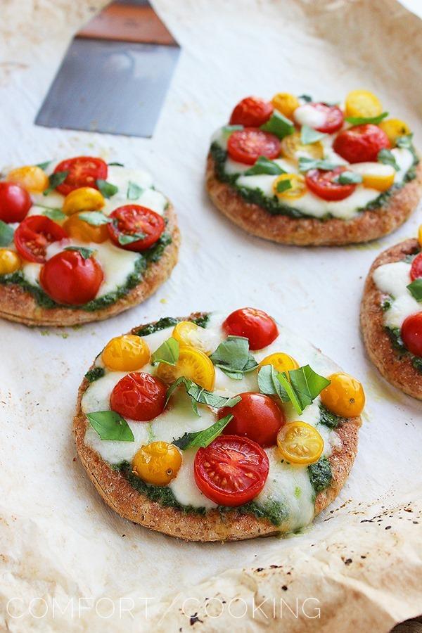 Mini Whole Wheat Pesto Caprese Pizzas – These healthy, colorful pizzas with fresh pesto make for a fun twist on dinner and an easy next-day lunch! | thecomfortofcooking.com