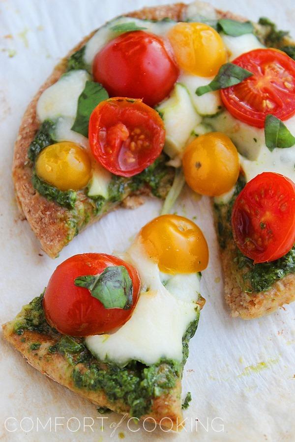 Mini Whole Wheat Pesto Caprese Pizzas – These healthy, colorful pizzas with fresh pesto make for a fun twist on dinner and an easy next-day lunch! | thecomfortofcooking.com