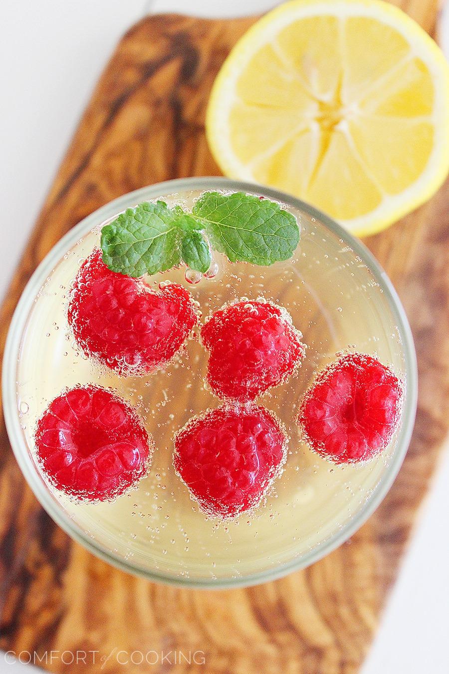 Limoncello Raspberry Prosecco Cooler – Kick back and relax with a sparkling summery sip... bubbly, lemony Prosecco with fresh raspberries and mint! | thecomfortofcooking.com