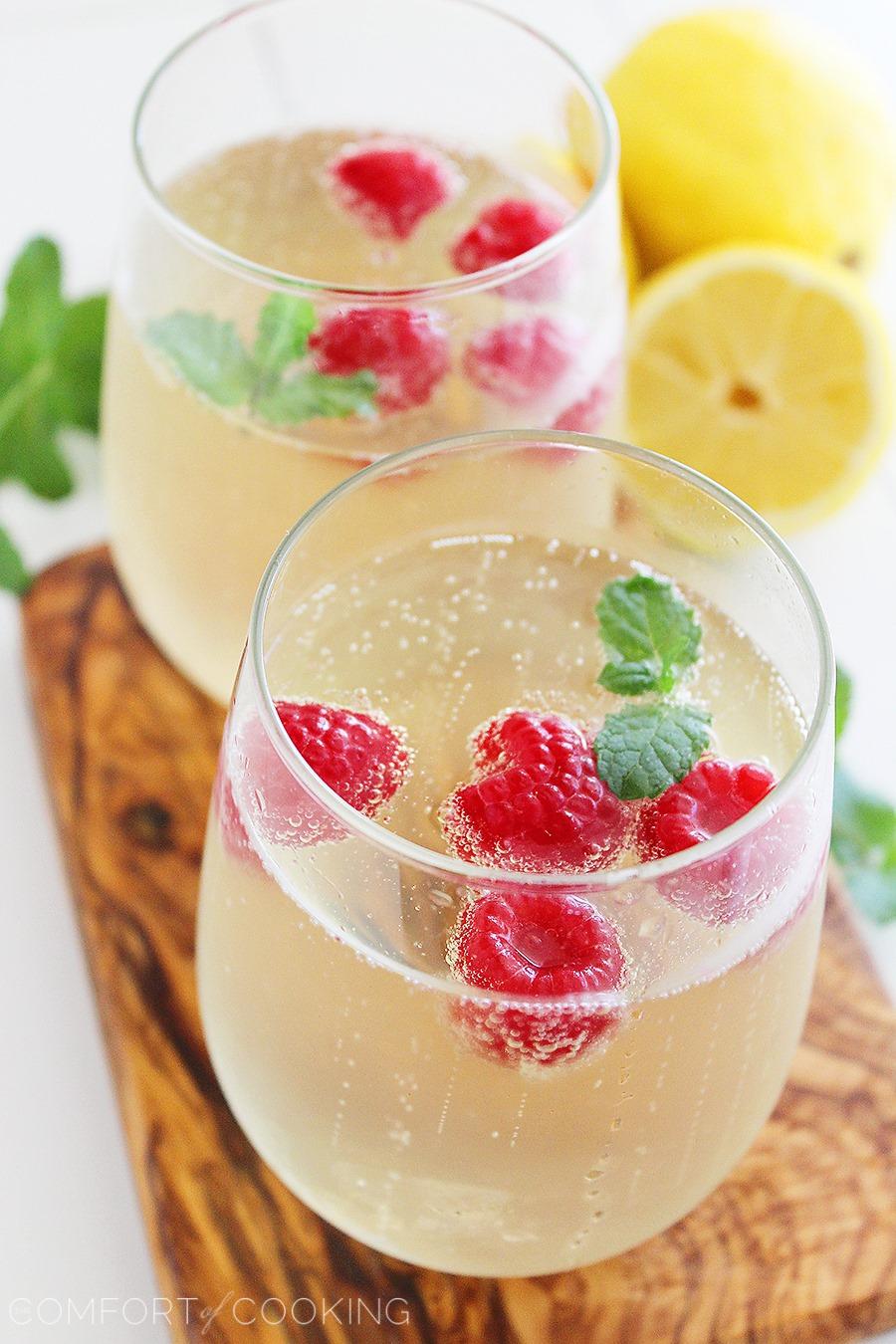 Limoncello Raspberry Prosecco Cooler – Kick back and relax with a sparkling summery sip... bubbly, lemony Prosecco with fresh raspberries and mint! | thecomfortofcooking.com