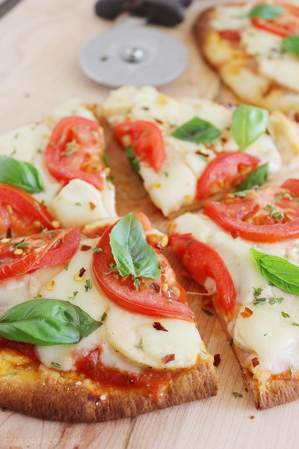 Cheesy Chicken Parmesan Flatbread Pizza – These cheesy, crisp chicken, mozzarella and tomato pizzas are so easy! Serve with a green salad for a healthy dinner. | thecomfortofcooking.com