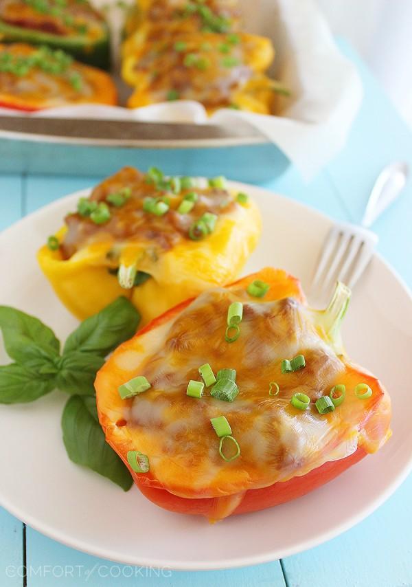 Sloppy Joe Stuffed Peppers –Two classic comfort foods combine to make one mouthwatering meal. You have GOT to try these cheesy, delicious stuffed peppers! | thecomfortofcooking.com