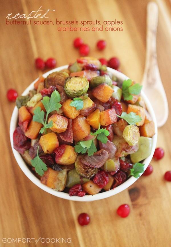 Roasted Butternut Squash and Brussels Sprouts with Cranberries, Apples and Onions – This colorful, healthy medley is so delicious, and also makes a delicious meal (or add cooked sausage). | thecomfortofcooking.com
