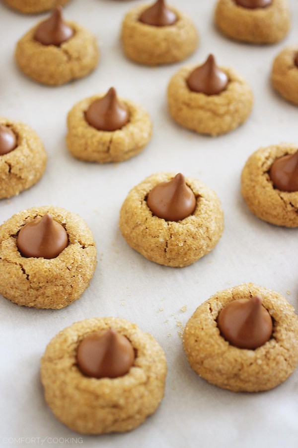 Chocolate Kissed Gingerbread Cookies - With a sparkly sugar coating and a creamy chocolate center, there's nothing not to love about these cookies. Made easily with a cake mix, adorably delicious, and a sweet holiday gift and party treat. | thecomfortofcooking.com