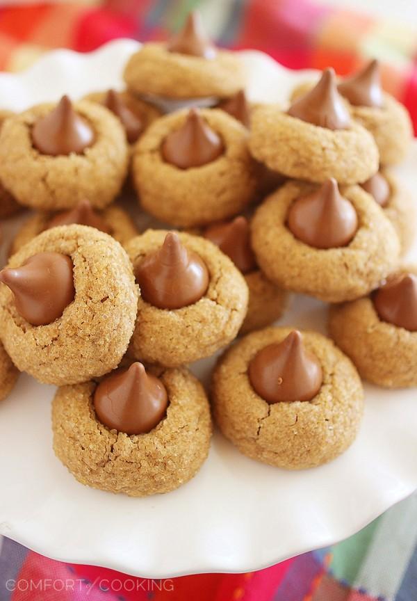 Chocolate Kissed Gingerbread Cookies - With a sparkly sugar coating and a creamy chocolate center, there's nothing not to love about these cookies. Made easily with a cake mix, adorably delicious, and a sweet holiday gift and party treat. | thecomfortofcooking.com