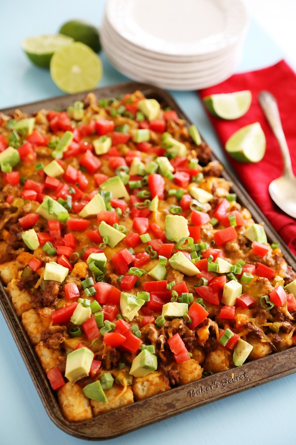 Cheesy Loaded Nacho Tater Tots – So easy, so cheesy and loaded with all the good stuff. Perfect for game day snacking! | thecomfortofcooking.com