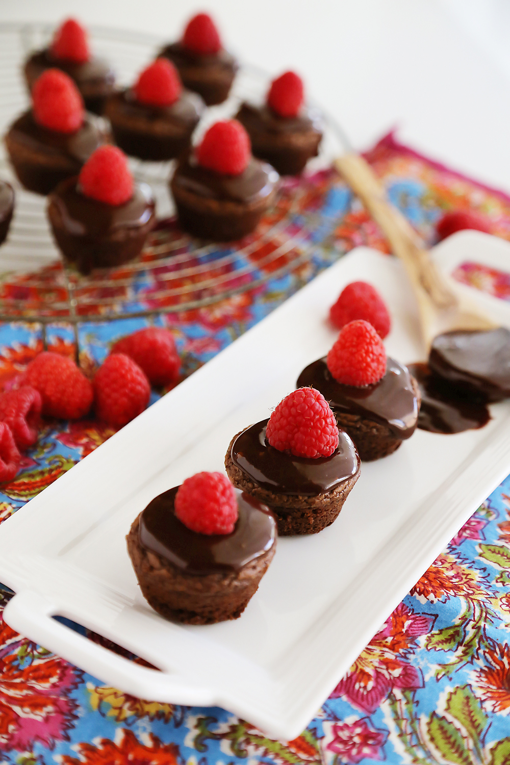 Easy Raspberry Ganache Brownie Bites - Fudgy brownie bites (baked in mini muffin tins) with chocolate ganache and raspberries are so easy and elegant! Thecomfortofcooking.com