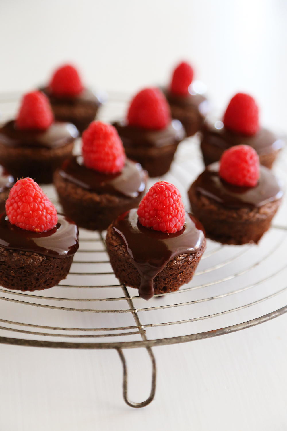 Easy Raspberry Ganache Brownie Bites - Fudgy brownie bites (baked in mini muffin tins) with chocolate ganache and raspberries are so easy and elegant! Thecomfortofcooking.com