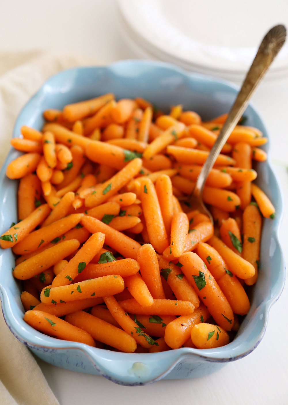 Honey-Glazed Baby Carrots – Tender crisp carrots with butter, brown sugar and nutmeg make a perfect one-skillet side! | thecomfortofcooking.com