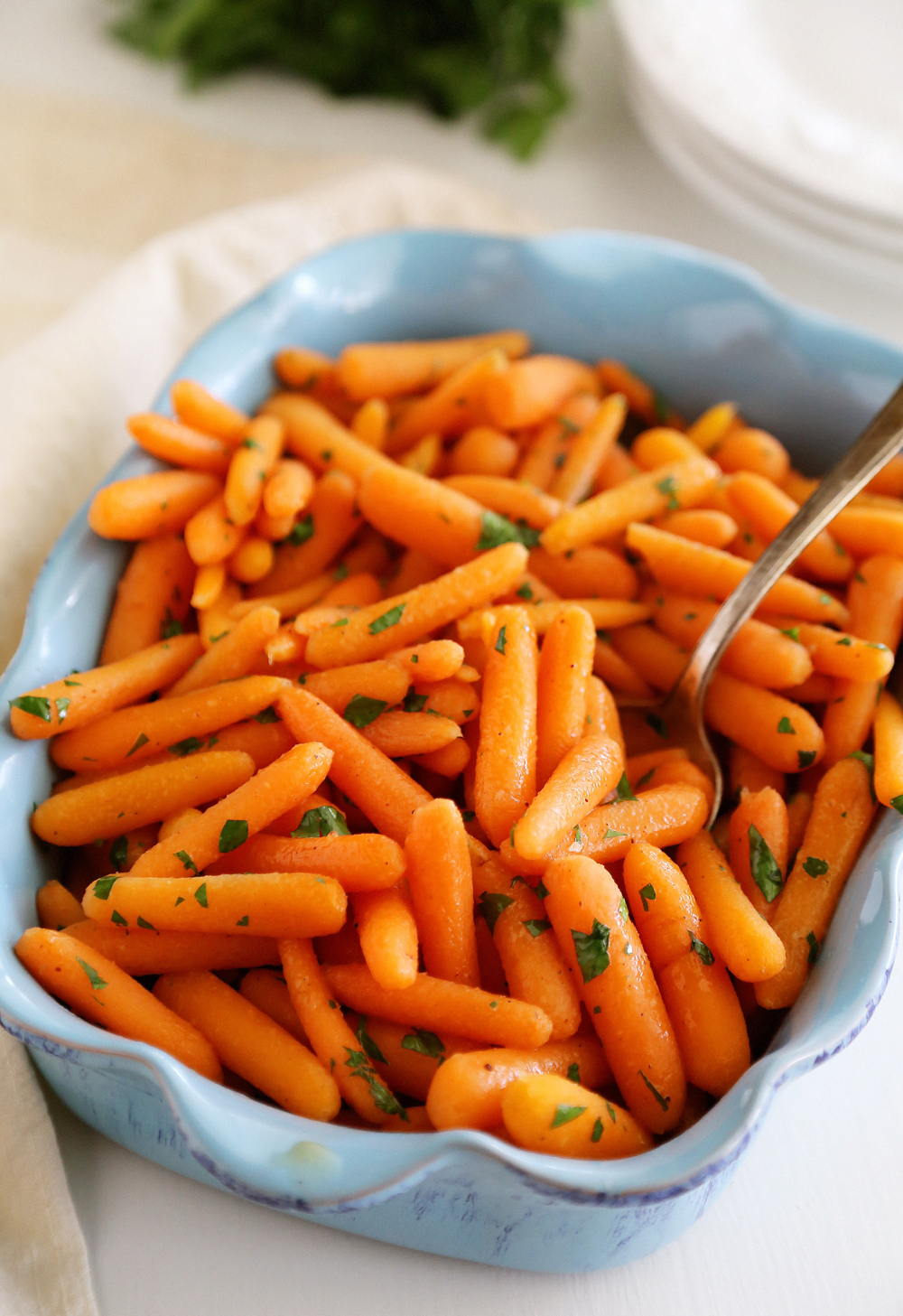 Honey-Glazed Baby Carrots – Tender crisp carrots with butter, brown sugar and nutmeg make a perfect one-skillet side! | thecomfortofcooking.com