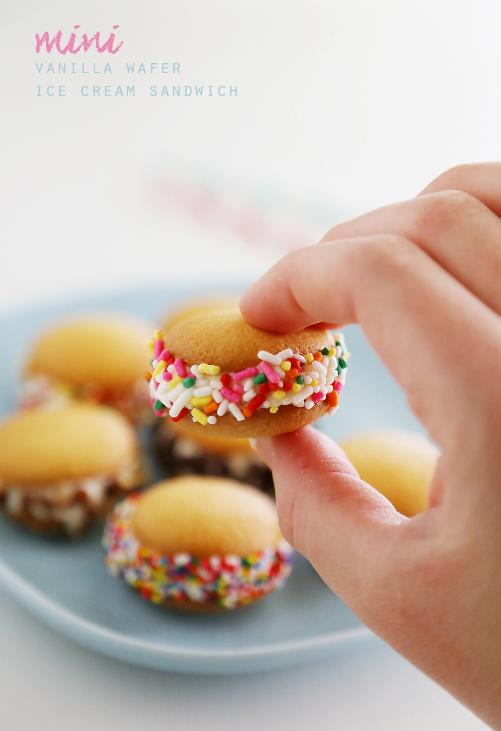 Mini Vanilla Wafer Ice Cream Sandwiches – The perfect quick + easy frozen treat! Roll in your favorite toppings and enjoy. thecomfortofcooking.com