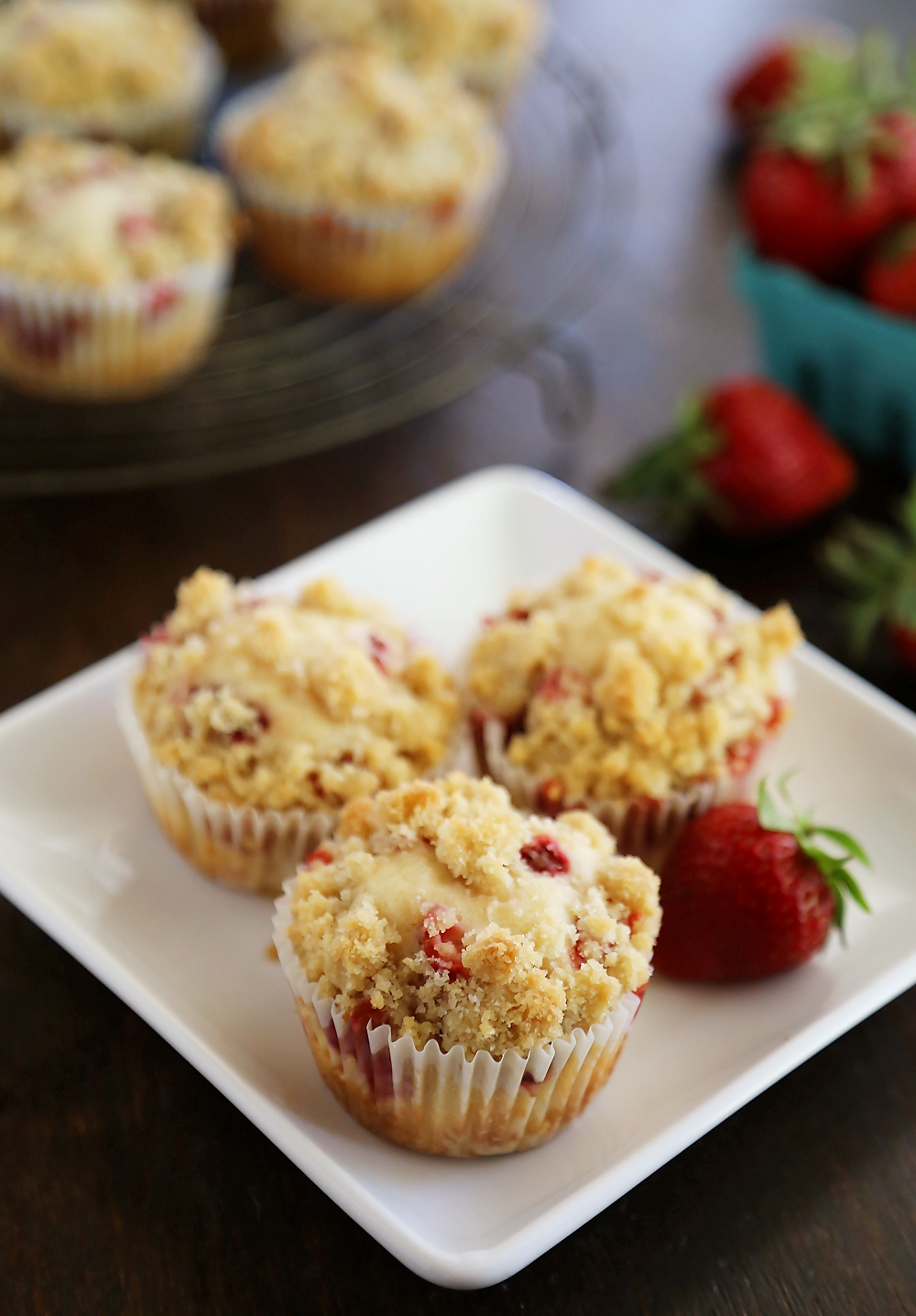 Strawberry Coffee Cake Muffins - Bursting with fresh berries and topped with a buttery coffee cake crumble. Thecomfortofcooking.com