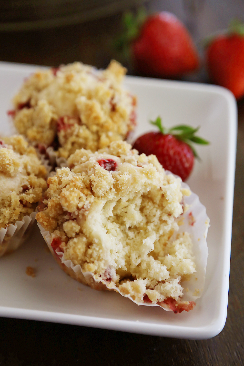 Strawberry Coffee Cake Muffins - Bursting with fresh berries and topped with a buttery coffee cake crumble. Thecomfortofcooking.com