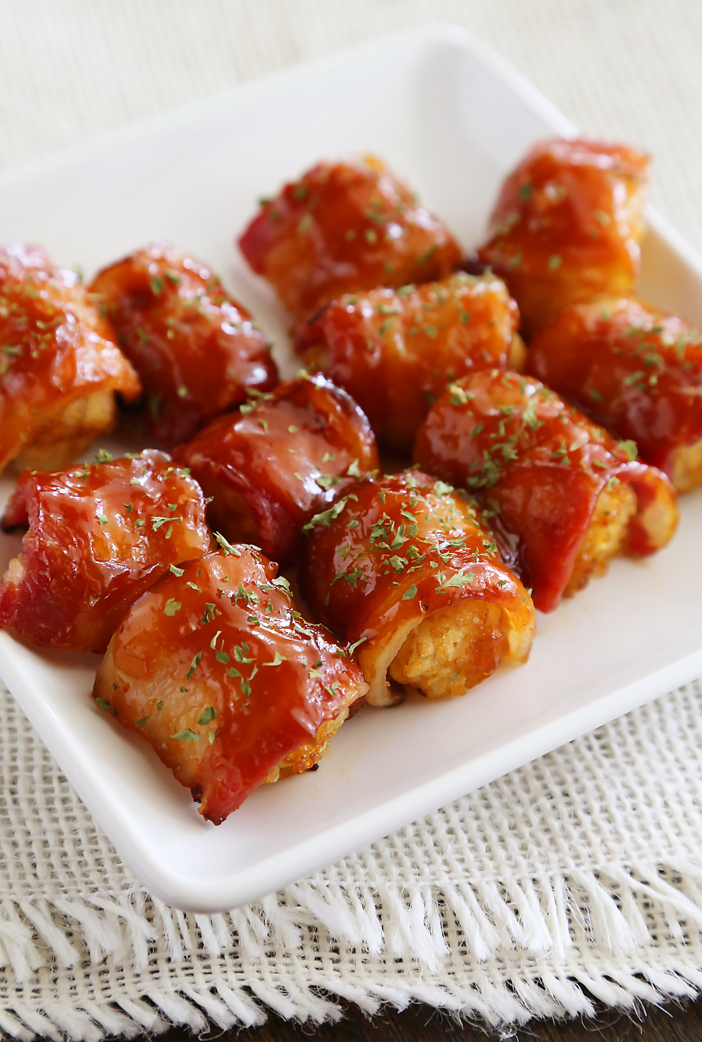 BBQ Bacon Wrapped Tater Tot Bites - Crispy tater tots wrapped in applewood smoked bacon and coated with a tangy homemade barbecue sauce! Thecomfortofcooking.com