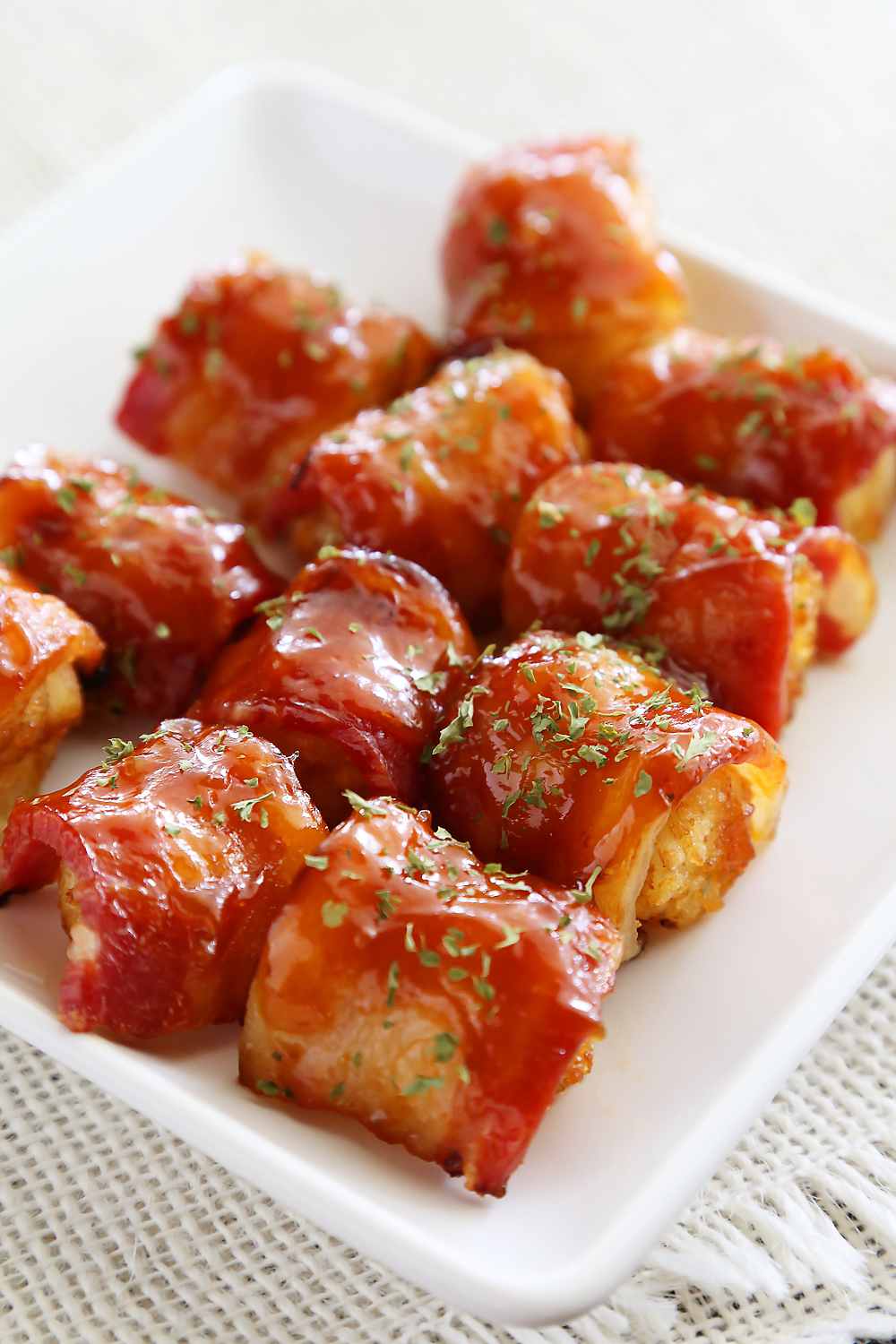 BBQ Bacon Wrapped Tater Tot Bites - Crispy tater tots wrapped in applewood smoked bacon and coated with a tangy homemade barbecue sauce! Thecomfortofcooking.com