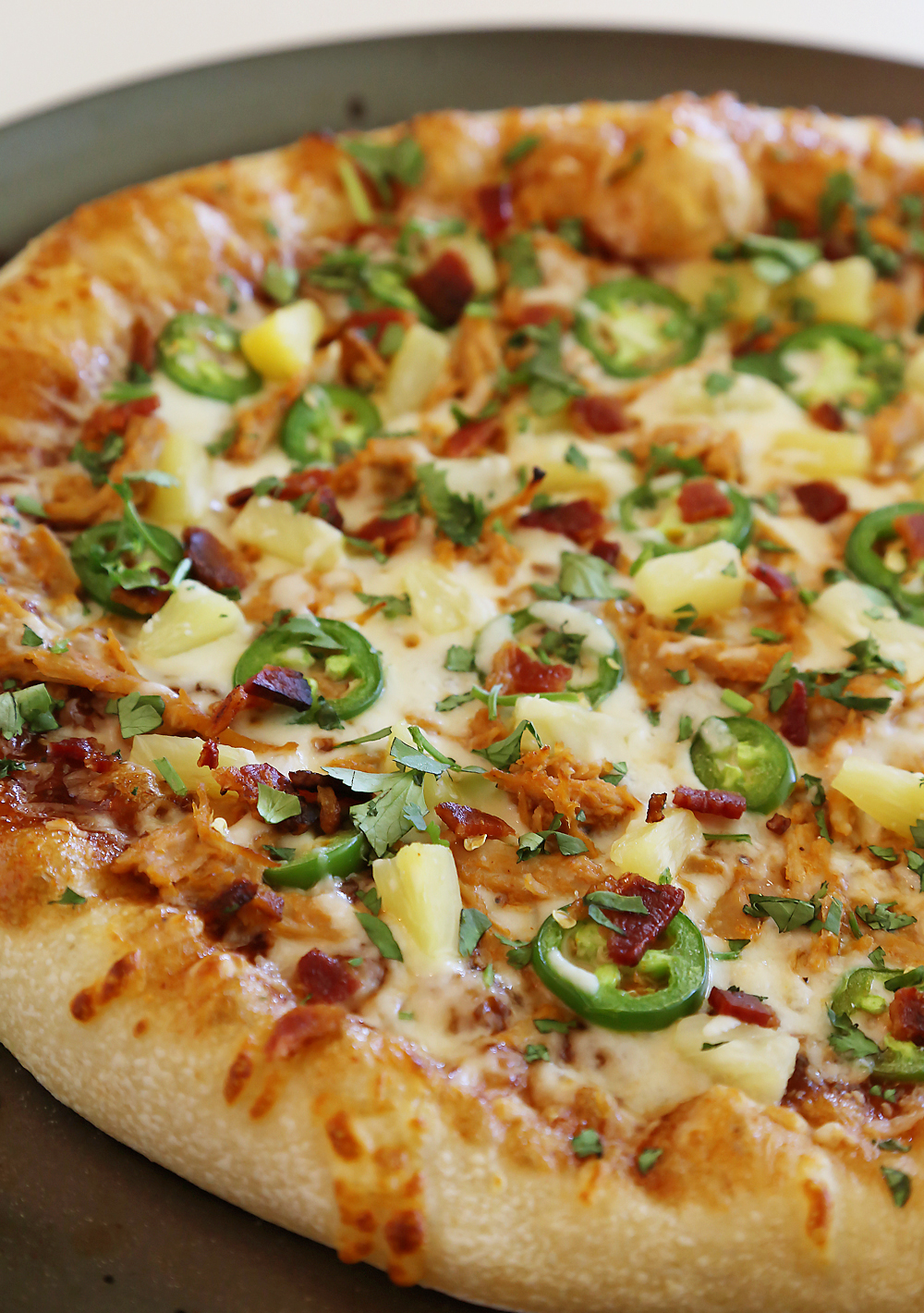 Pulled Pork Jalapeno Pineapple Pizza with Bacon and Cilantro – Gooey, cheesy pizza (plus dough recipe) that makes the perfect summer meal! Thecomfortofcooking.com