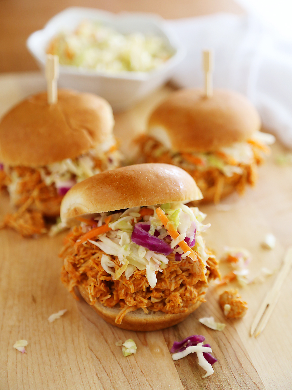 Slow Cooker Buffalo Chicken Sliders - Serve this tangy, tender slow cooked buffalo chicken on buttery toasted buns, or as lettuce wraps! Thecomfortofcooking.com
