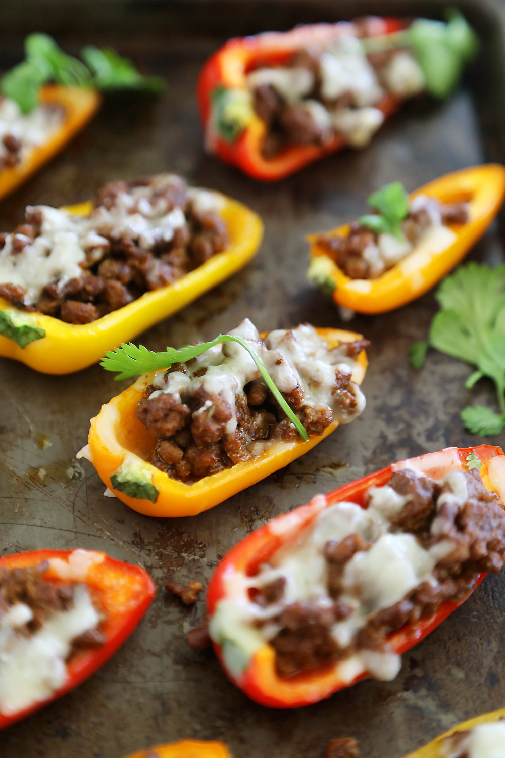 Mini Taco Stuffed Peppers with Cilantro Cream Sauce - Easy 5-ingredient spicy taco stuffed peppers with a creamy cool sauce. Thecomfortofcooking.com