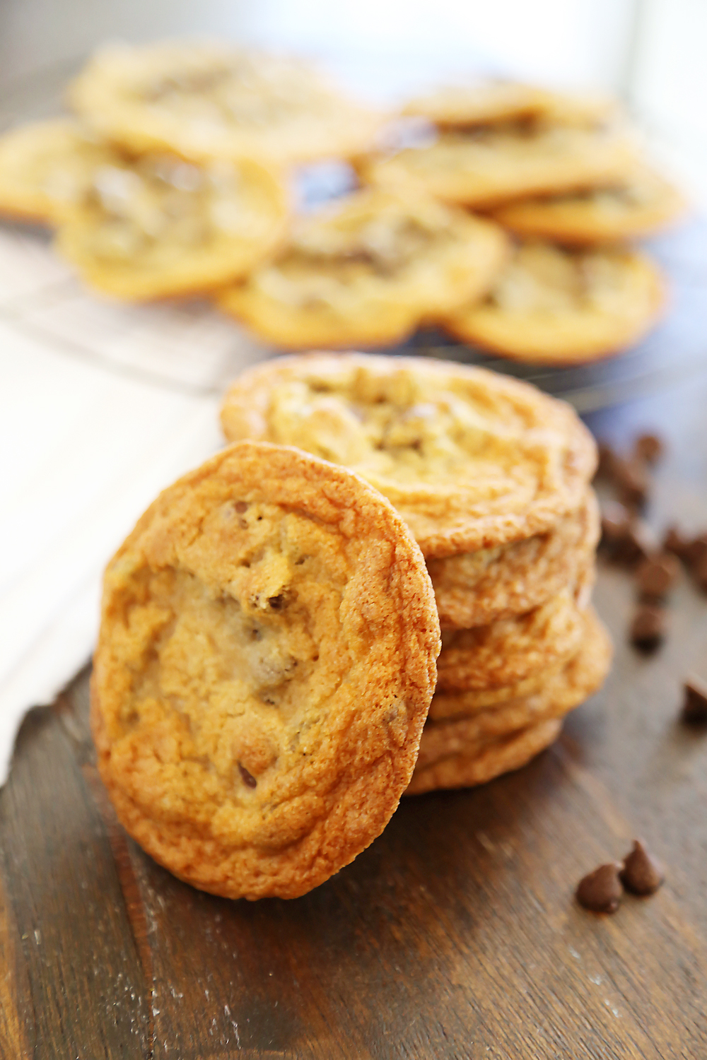 Thin and Chewy Chocolate Chip Cookies – Super buttery, chewy and irresistibly easy. Bake up a batch today! thecomfortofcooking.com
