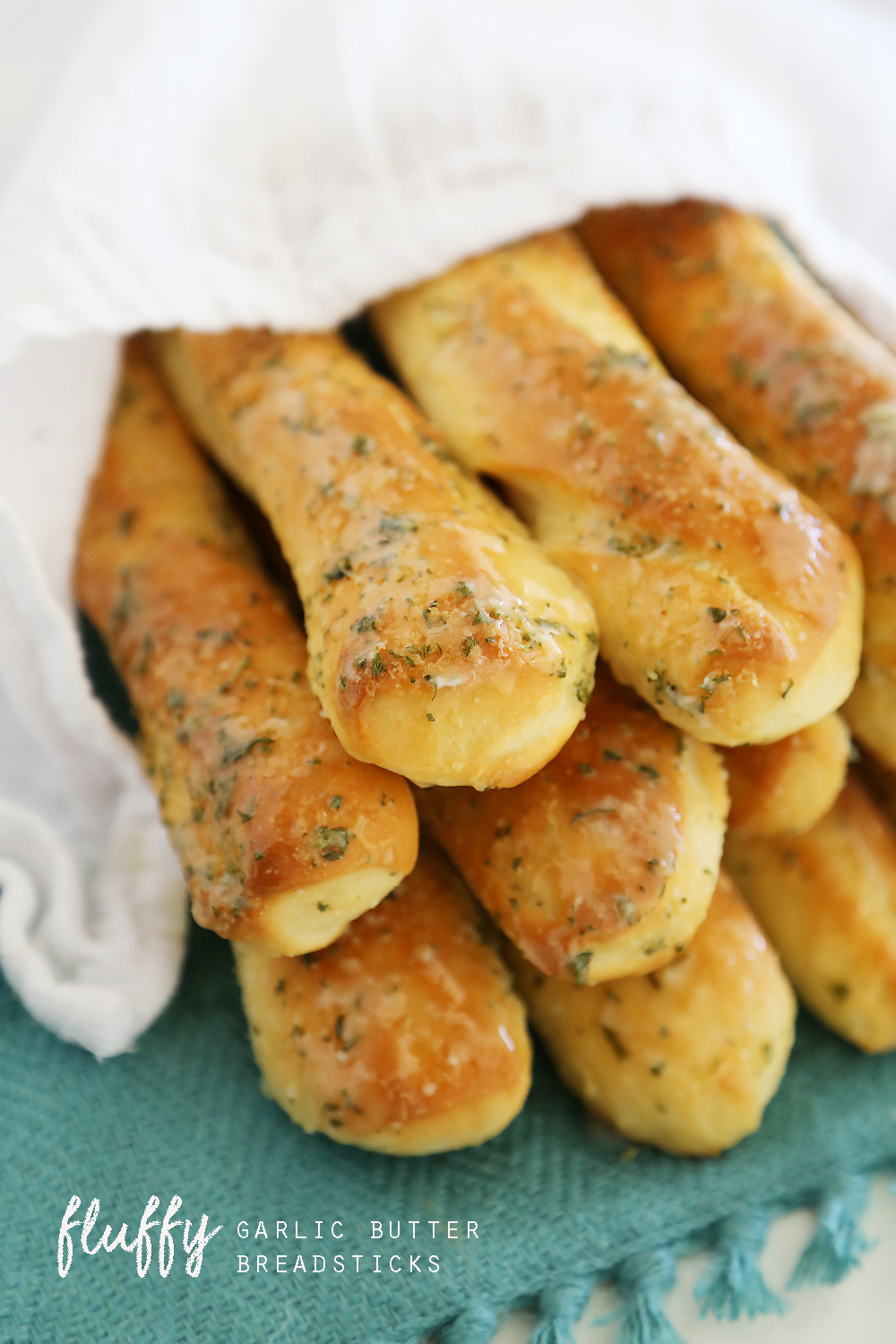 Fluffy Garlic Butter Breadsticks – Super soft, buttery Olive Garden-style breadsticks made easily from scratch! thecomfortofcooking.com