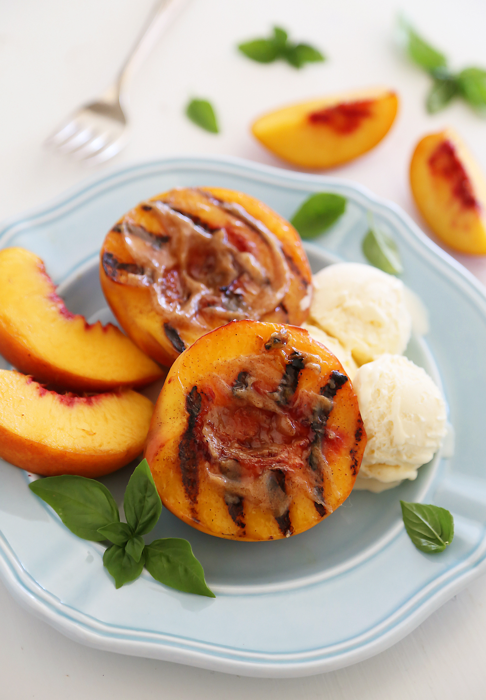 Grilled Peaches with Cinnamon-Sugar Butter – Juicy, sweet grilled summer peaches make a mouthwatering dessert with vanilla ice cream or whipped cream! thecomfortofcooking.com