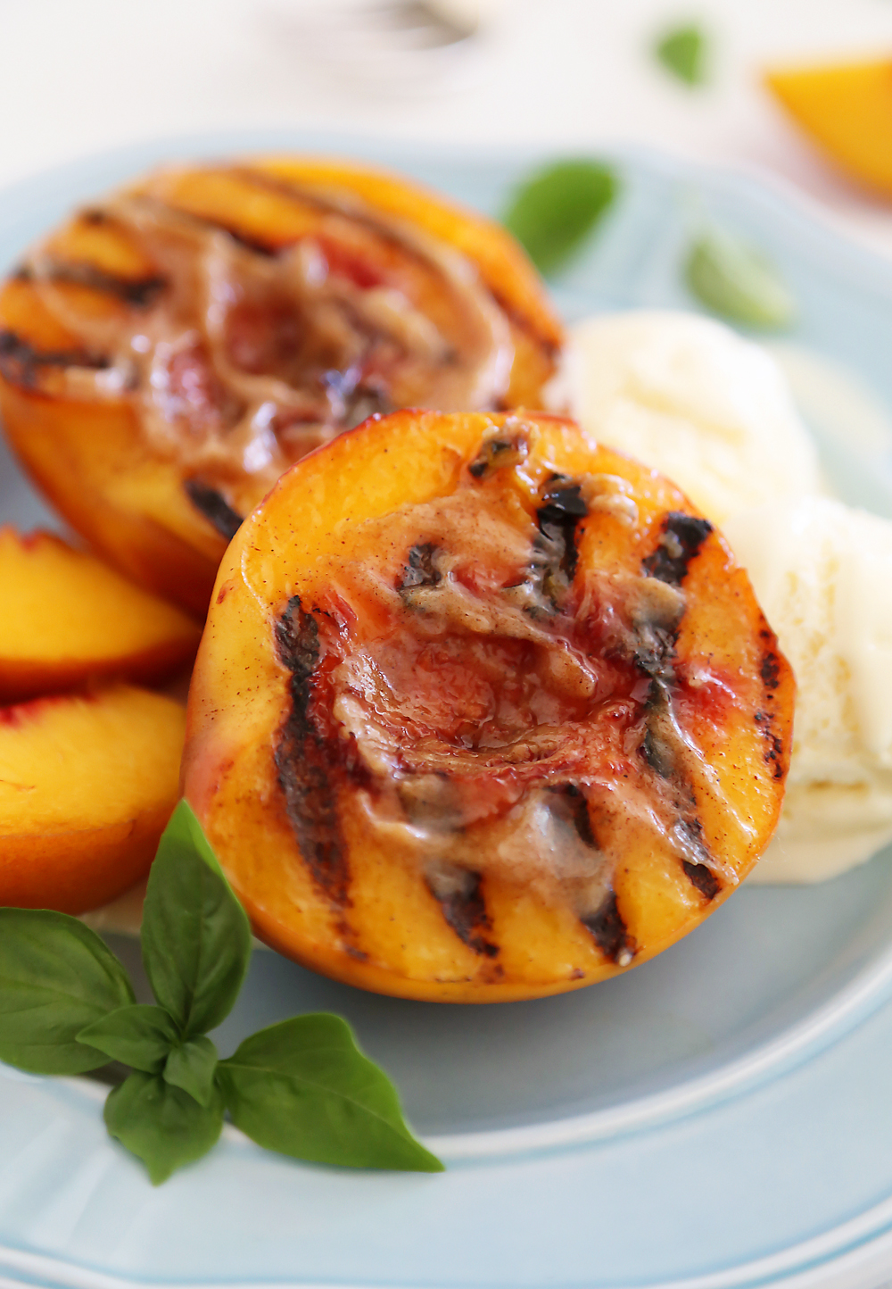 Grilled Peaches with Cinnamon-Sugar Butter – Juicy, sweet grilled summer peaches make a mouthwatering dessert with vanilla ice cream or whipped cream! thecomfortofcooking.com