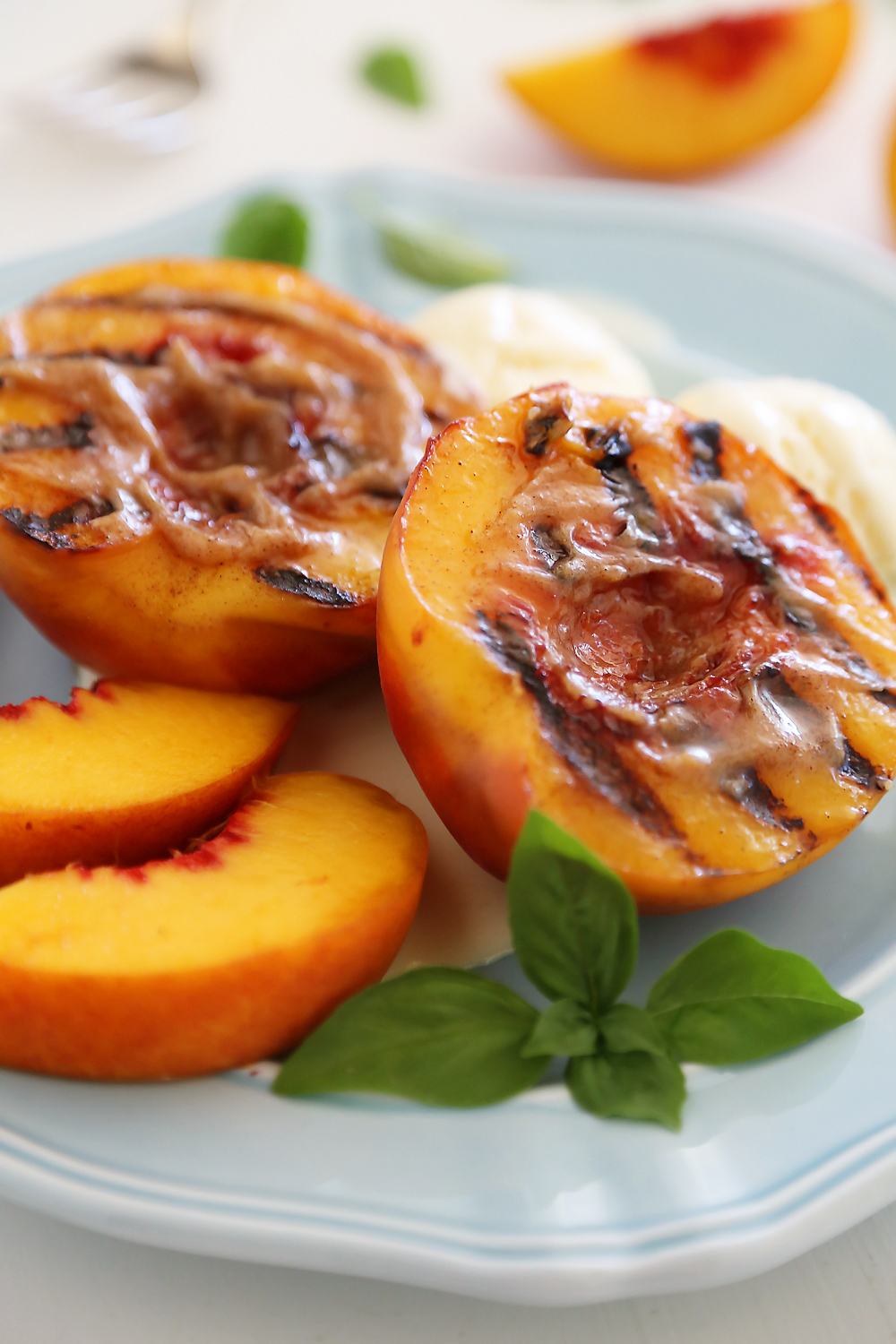 Grilled Peaches with Cinnamon-Sugar Butter – Juicy, sweet grilled summer peaches make a mouthwatering dessert with vanilla ice cream or whipped cream! thecomfortofcooking.com