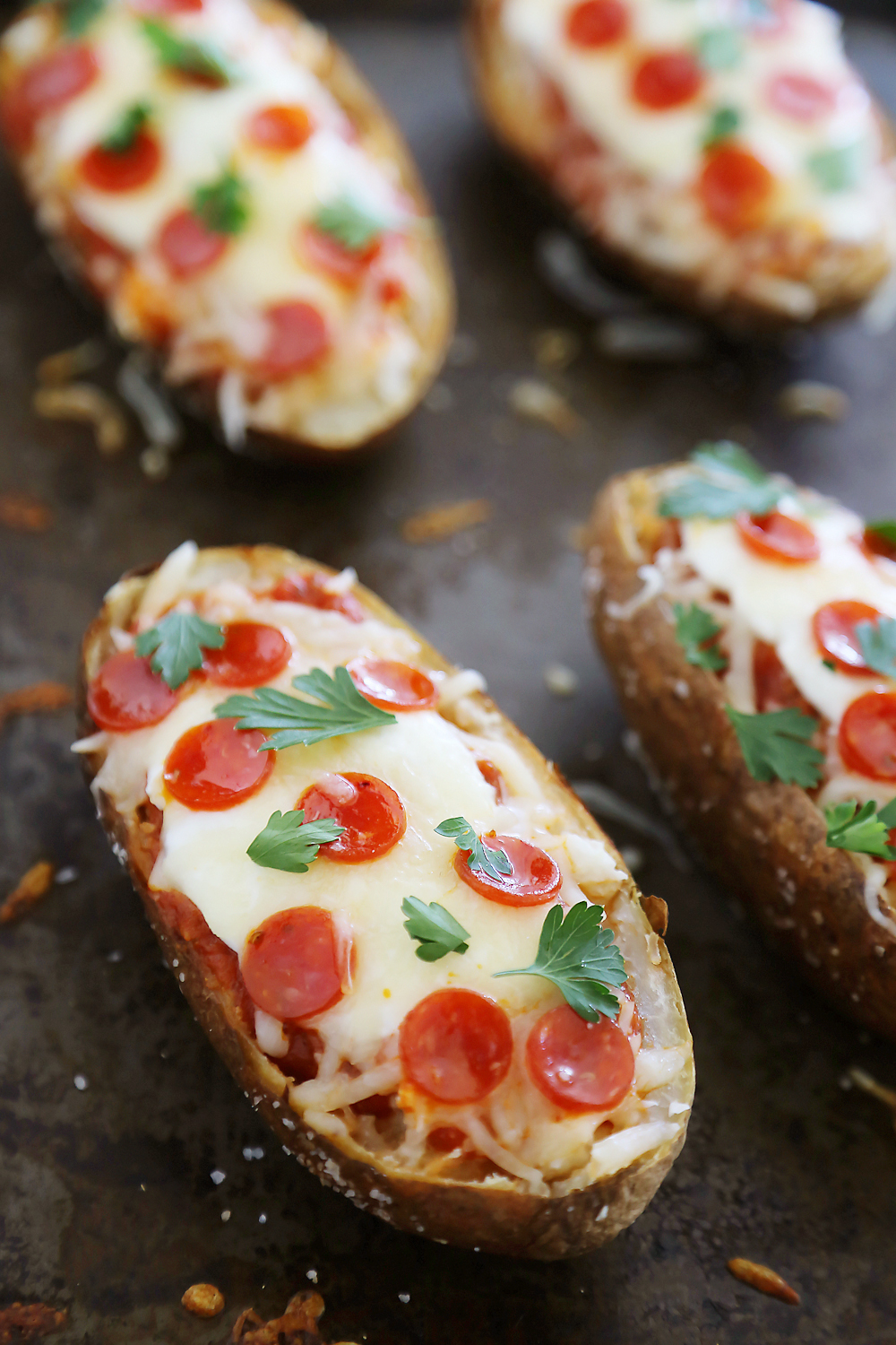 Pepperoni Pizza Potato Skins - Hearty, crispy potato skins meet cheesy pepperoni pizza! A perfect party appetizer. Thecomfortofcooking.com