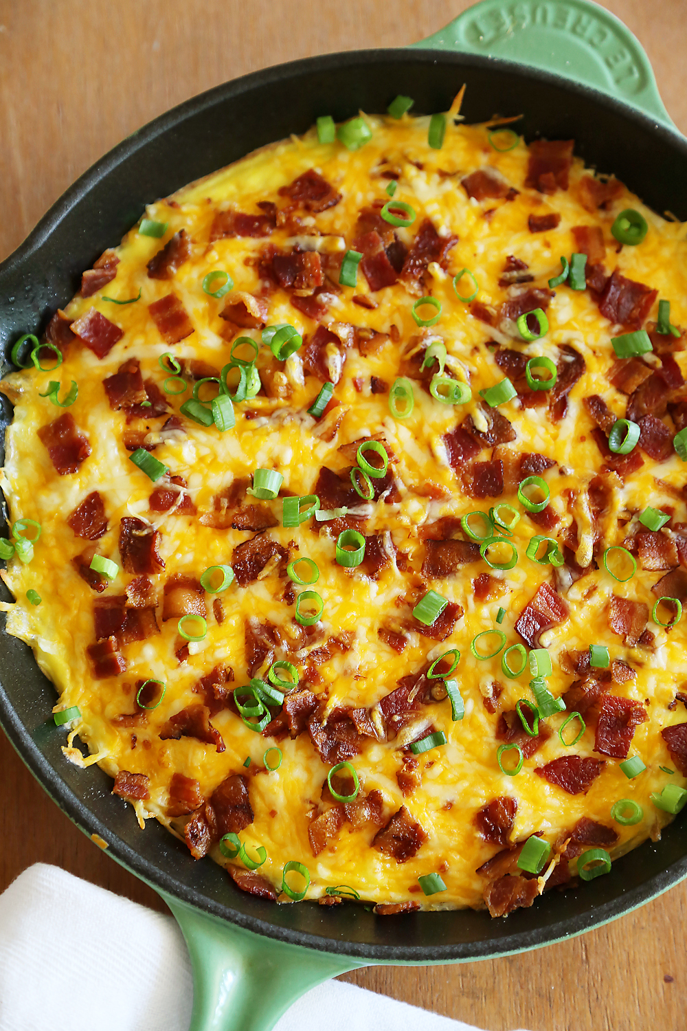 Cheesy Bacon Potato Frittata - Easy bacon-egg-cheddar frittata with potato crust makes a mouthwatering meal anytime of day! Thecomfortofcooking.com