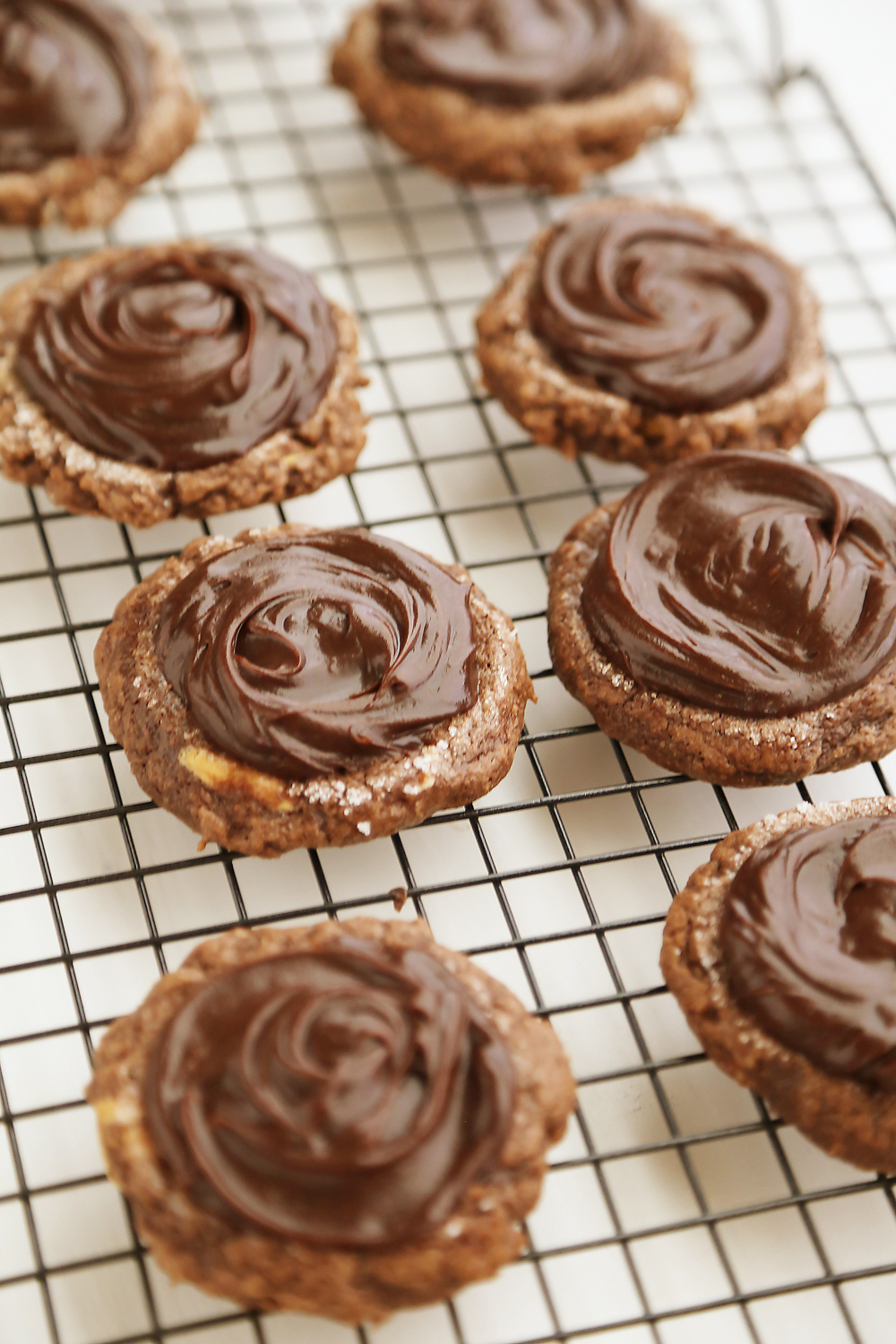 Frosted Peanut Butter Brownie Cookies - Gooey, fudgy chocolate brownie cookies with a surprise peanut butter center! Thecomfortofcooking.com