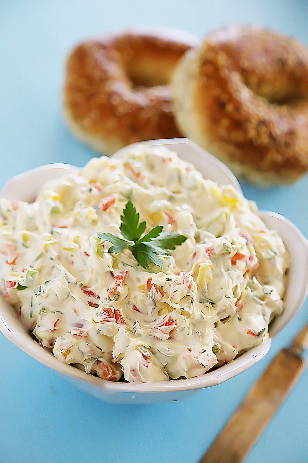 Whipped Garlic Veggie Cream Cheese – So easy and versatile! Spread on toasted bagels, or mix in to pasta sauce for decadent creaminess. Thecomfortofcooking.com