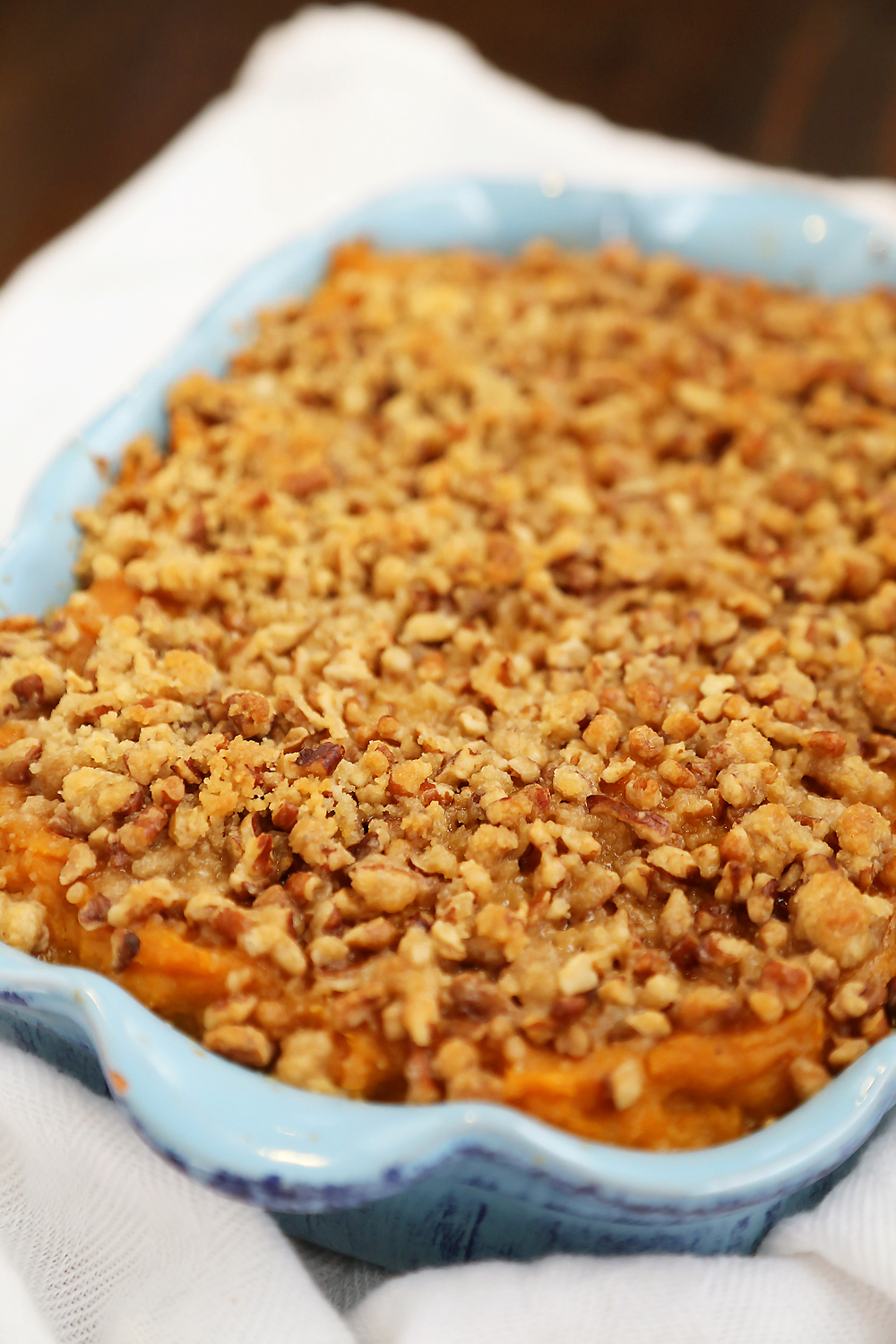 Buttery Brown Sugar Sweet Potato Casserole - Creamy, smooth sweet potato side with streusel topping is easy + sure to hit the spot for holiday feasting! thecomfortofcooking.com