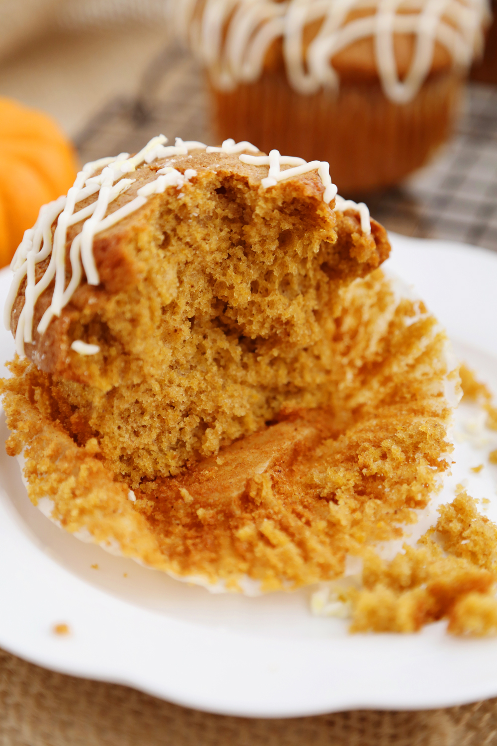 Vanilla Glazed Pumpkin Gingerbread Muffins - Super soft, richly spiced pumpkin muffins made easily in one bowl! So simple, delicious and perfect for homemade gifts. Thecomfortofcooking.com
