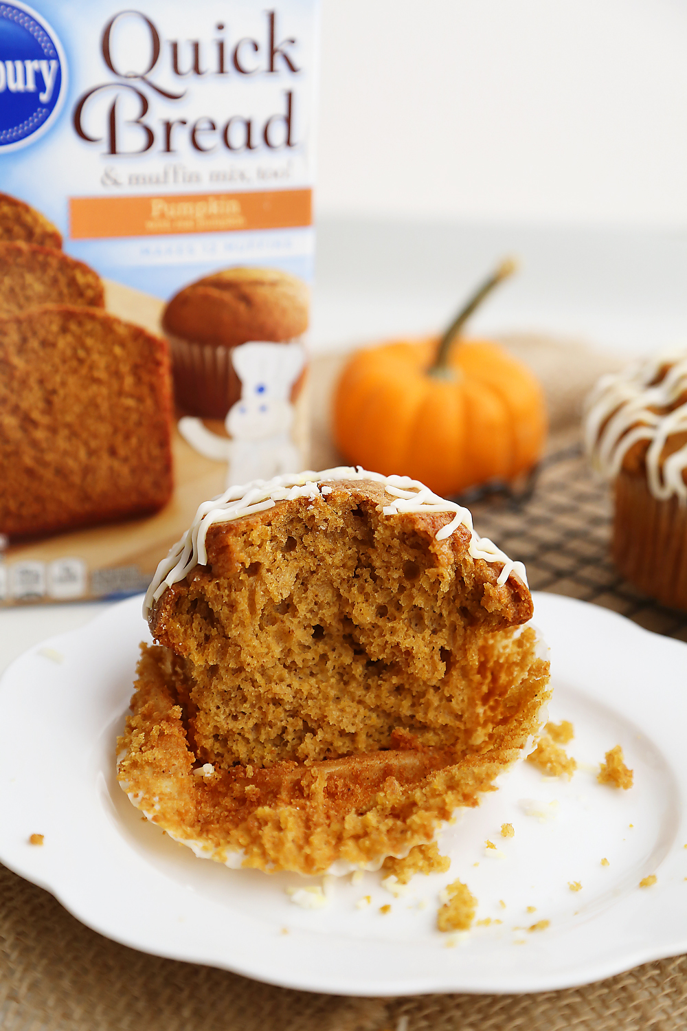 Vanilla Glazed Pumpkin Gingerbread Muffins - Super soft, richly spiced pumpkin muffins made easily in one bowl! So simple, delicious and perfect for homemade gifts. Thecomfortofcooking.com