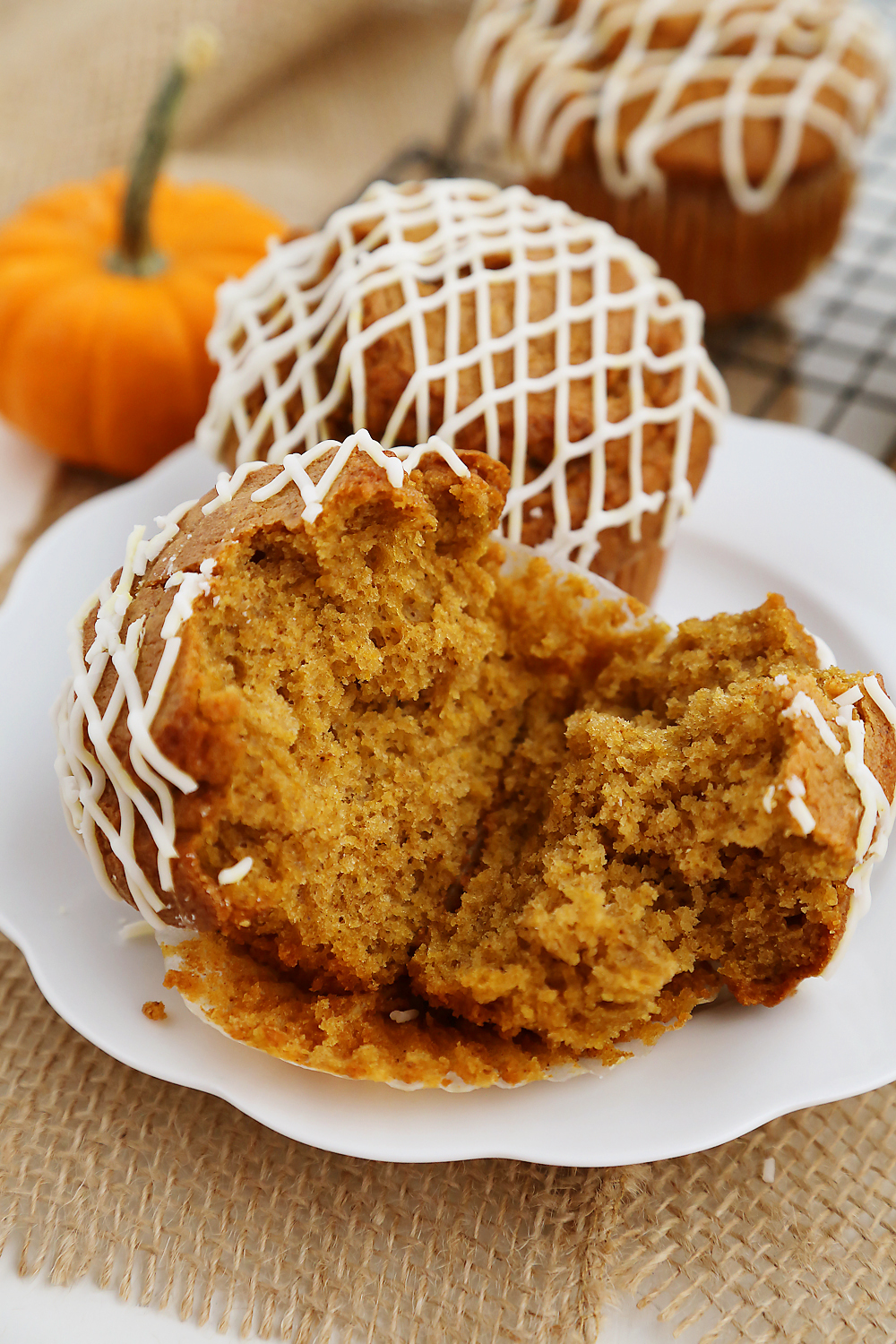 Vanilla Glazed Pumpkin Gingerbread Muffins - Super soft, richly spiced pumpkin muffins made easily in one bowl! So simple, delicious and perfect for homemade gifts. Thecomfortofcooking.com