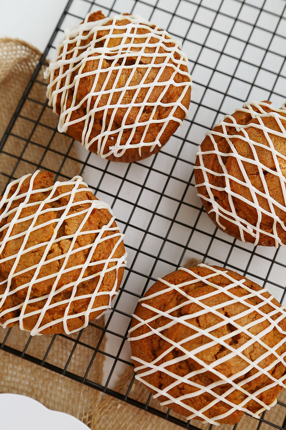 Vanilla Glazed Pumpkin Gingerbread Muffins - Super soft, richly spiced pumpkin muffins made easily in one bowl! So simple, delicious and perfect for homemade gifts. Thecomfortofcooking.com