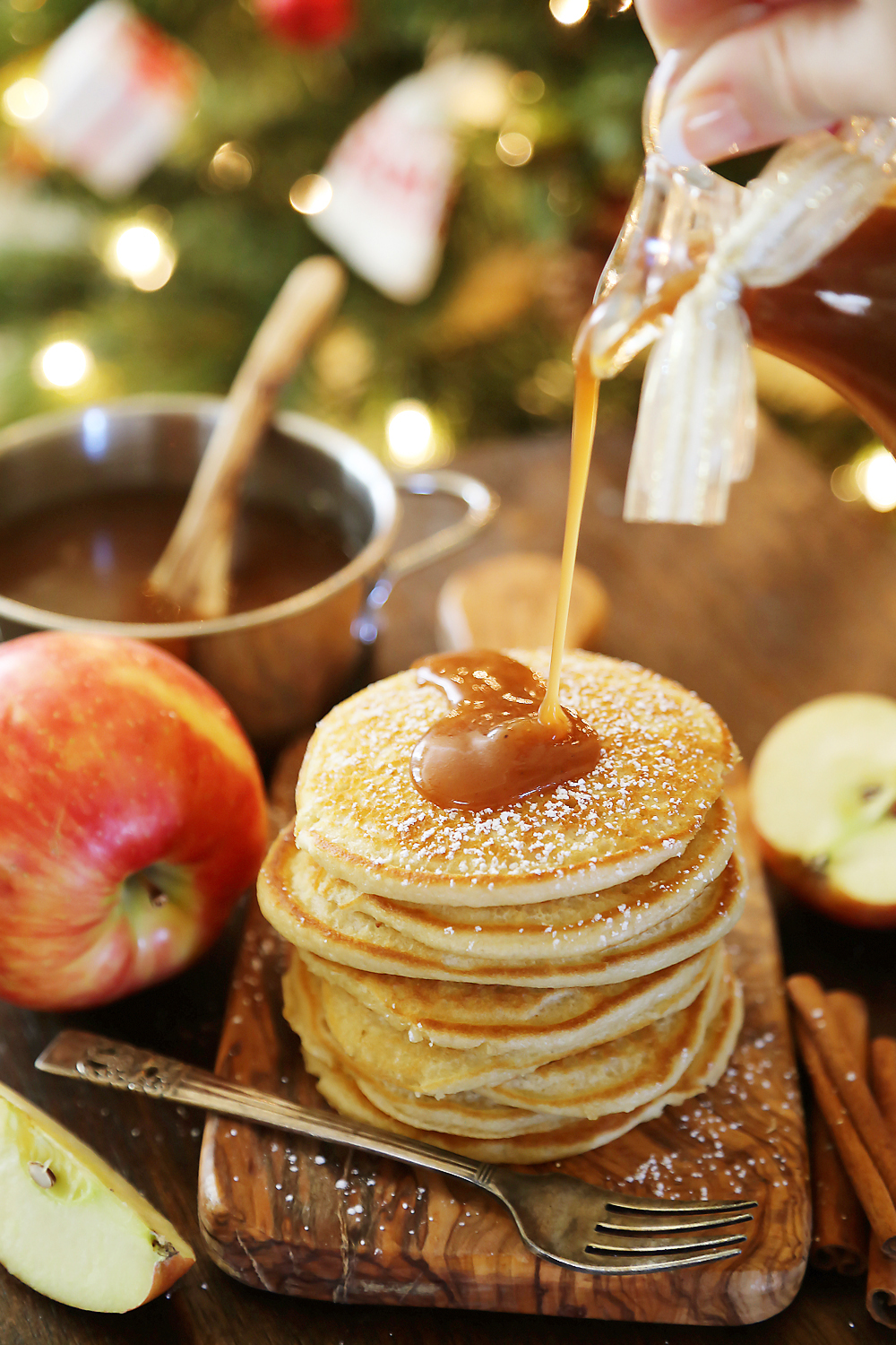 Easy Homemade Apple Cider Syrup – Velvety rich, cinnamon-spiced syrup is perfect on hot pancakes, waffles or French toast. Use in any recipe that calls for maple syrup + give as gifts! Thecomfortofcooking.com