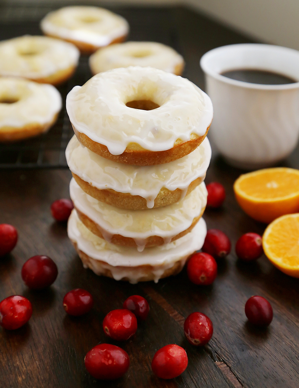 Glazed Cranberry Orange Donuts - Super soft, tangy-sweet donuts with fresh cranberries and orange zest! thecomfortofcooking.com