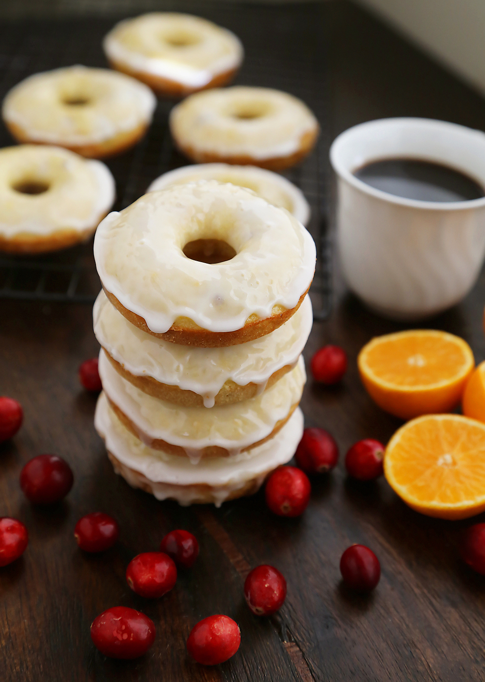 Glazed Cranberry Orange Donuts - Super soft, tangy-sweet donuts with fresh cranberries and orange zest! thecomfortofcooking.com