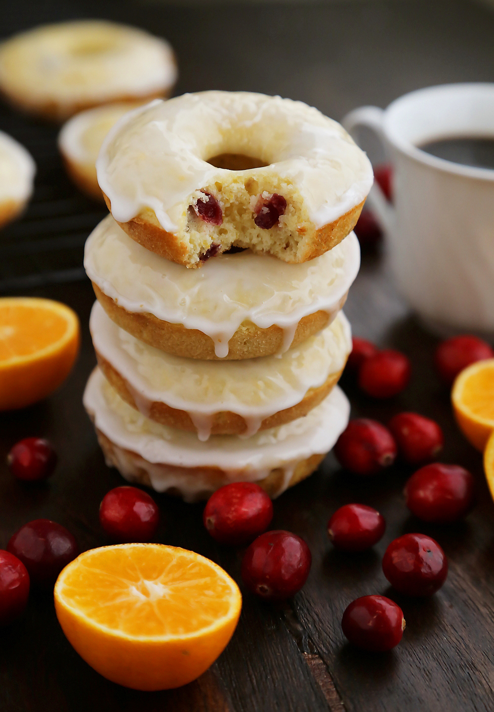 Glazed Cranberry Orange Donuts - Super soft, tangy-sweet donuts with fresh cranberries and orange zest! thecomfortofcooking.com