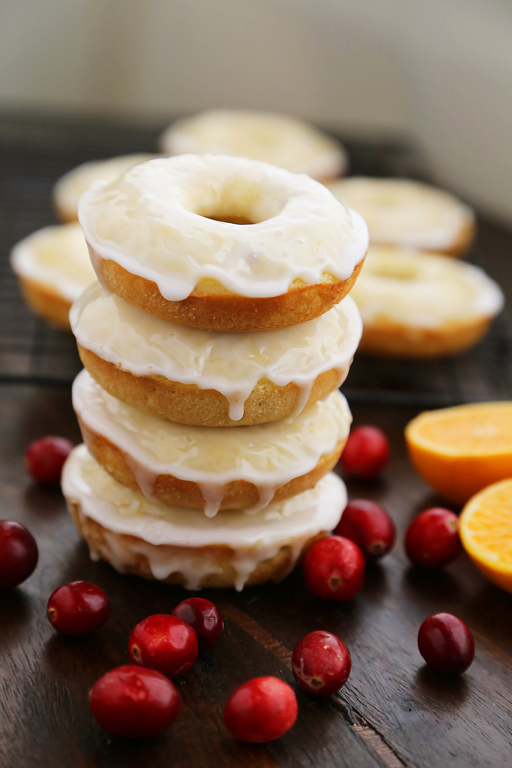 Glazed Cranberry Orange Donuts - Super soft, tangy-sweet donuts with fresh cranberries and orange zest! thecomfortofcooking.com