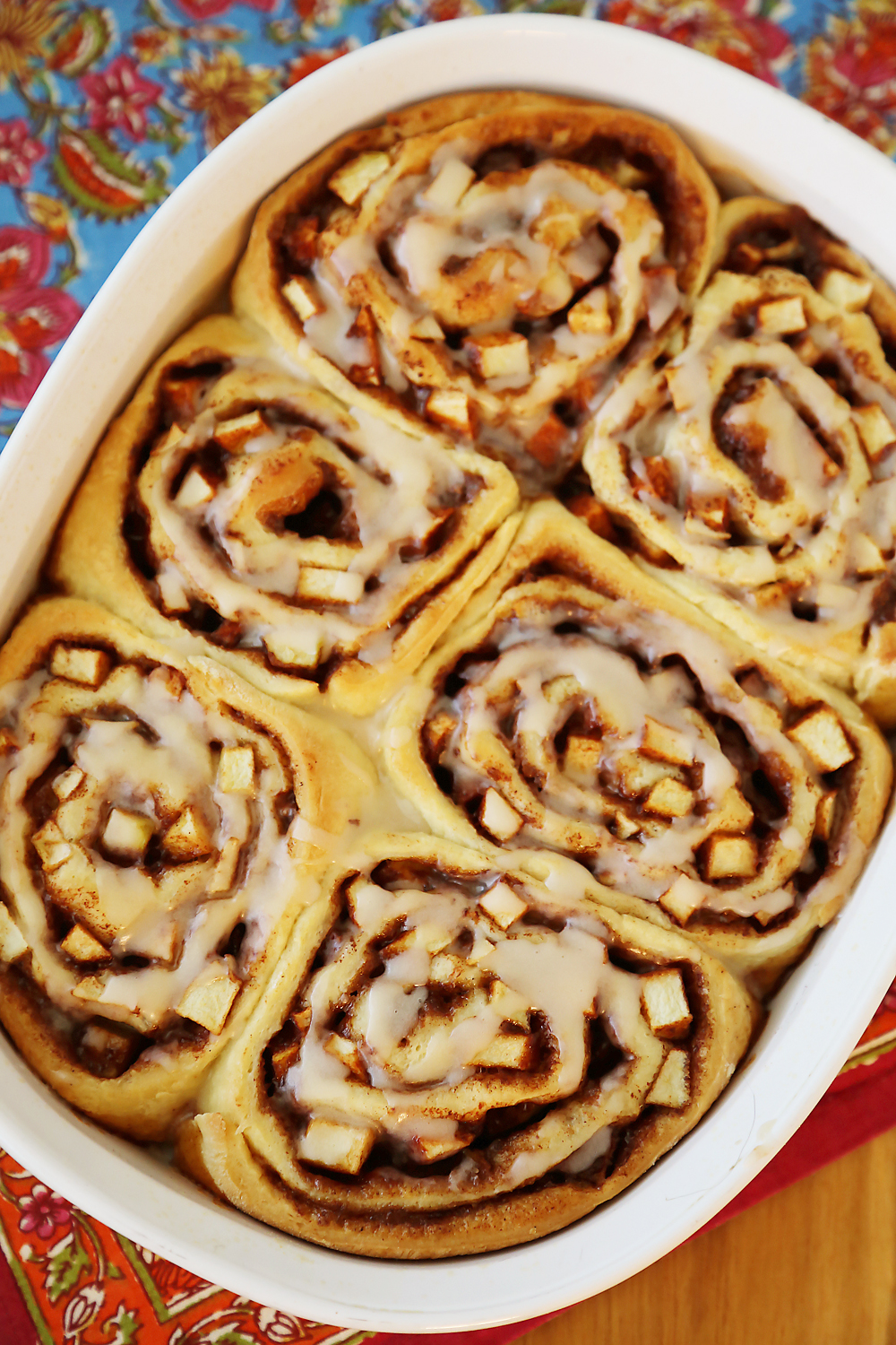 Gooey Apple Pie Cinnamon Rolls - These sticky, soft cinnamon rolls with fresh apples taste like the classic pie and breakfast treat rolled into one! Thecomfortofcooking.com