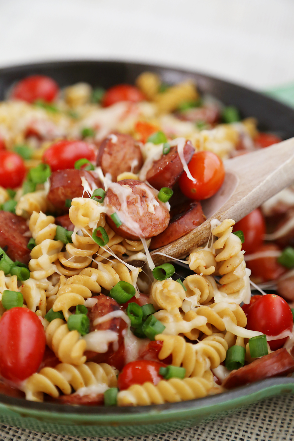 Cheesy Sausage and Tomato Pasta Skillet – This 15-minute dinner is so delicious and easy to whip up on weeknights! Thecomfortofcooking.com