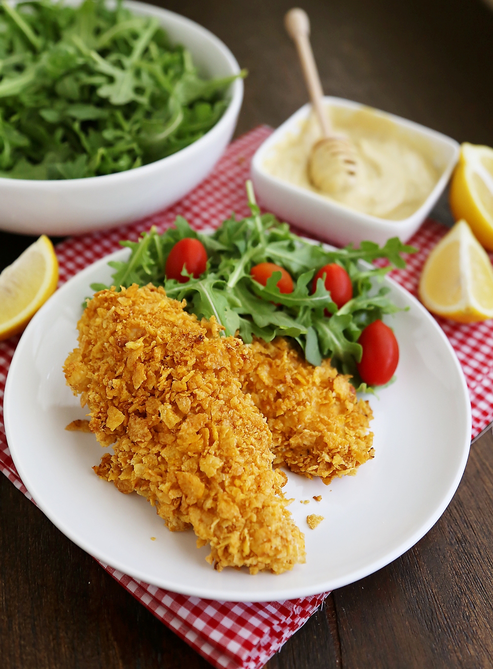 Crispy Honey-Dijon Baked Chicken Tenders - Cornflake crusted chicken with honey mustard dipping sauce (recipe included) makes a perfect weeknight meal that kids and adults will love! Thecomfortofcooking.com