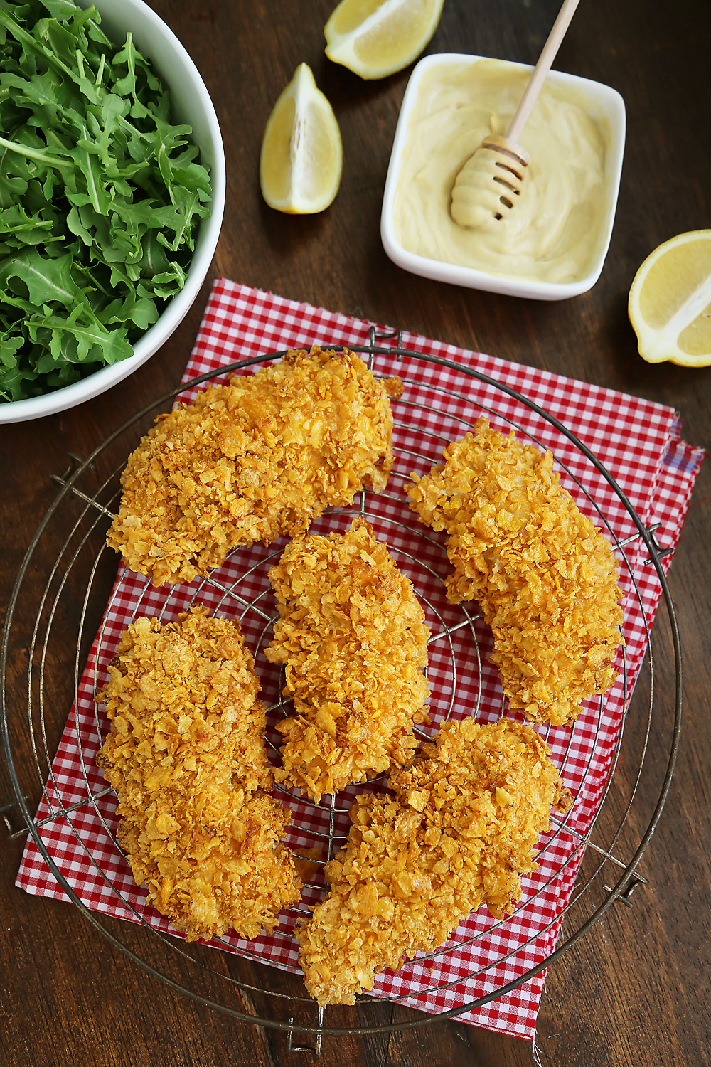 Crispy Honey-Dijon Baked Chicken Tenders - Cornflake crusted chicken with honey mustard dipping sauce (recipe included) makes a perfect weeknight meal that kids and adults will love! Thecomfortofcooking.com