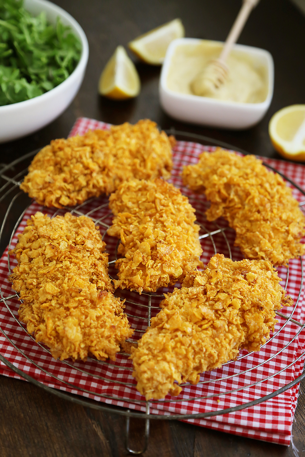 Crispy Honey-Dijon Baked Chicken Tenders - Cornflake crusted chicken with honey mustard dipping sauce (recipe included) makes a perfect weeknight meal that kids and adults will love! Thecomfortofcooking.com