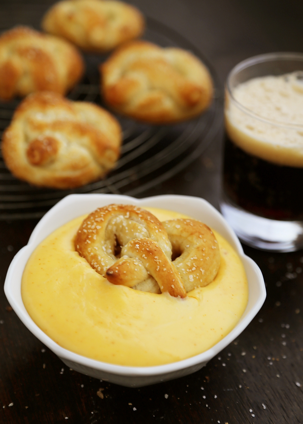 Easy Mini Soft Pretzels + Cheese Sauce – Fluffy, salty pretzels made quick + easy with pizza dough! Serve with spicy mustard or a homemade cheese sauce (recipe included). thecomfortofcooking.com