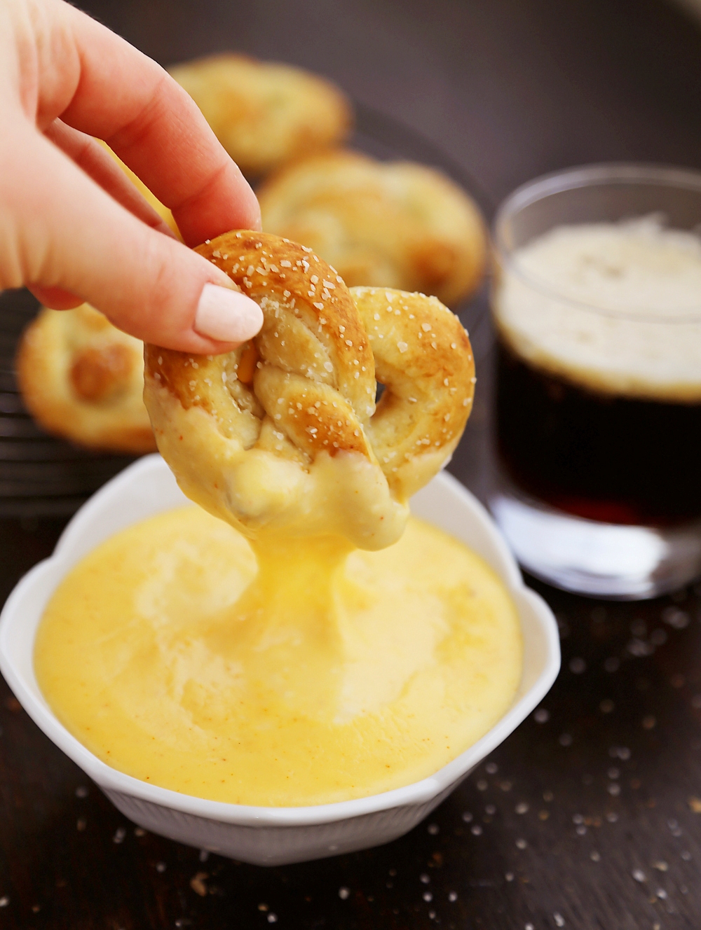 Easy Mini Soft Pretzels + Cheese Sauce – Fluffy, salty pretzels made quick + easy with pizza dough! Serve with spicy mustard or a homemade cheese sauce (recipe included). thecomfortofcooking.com