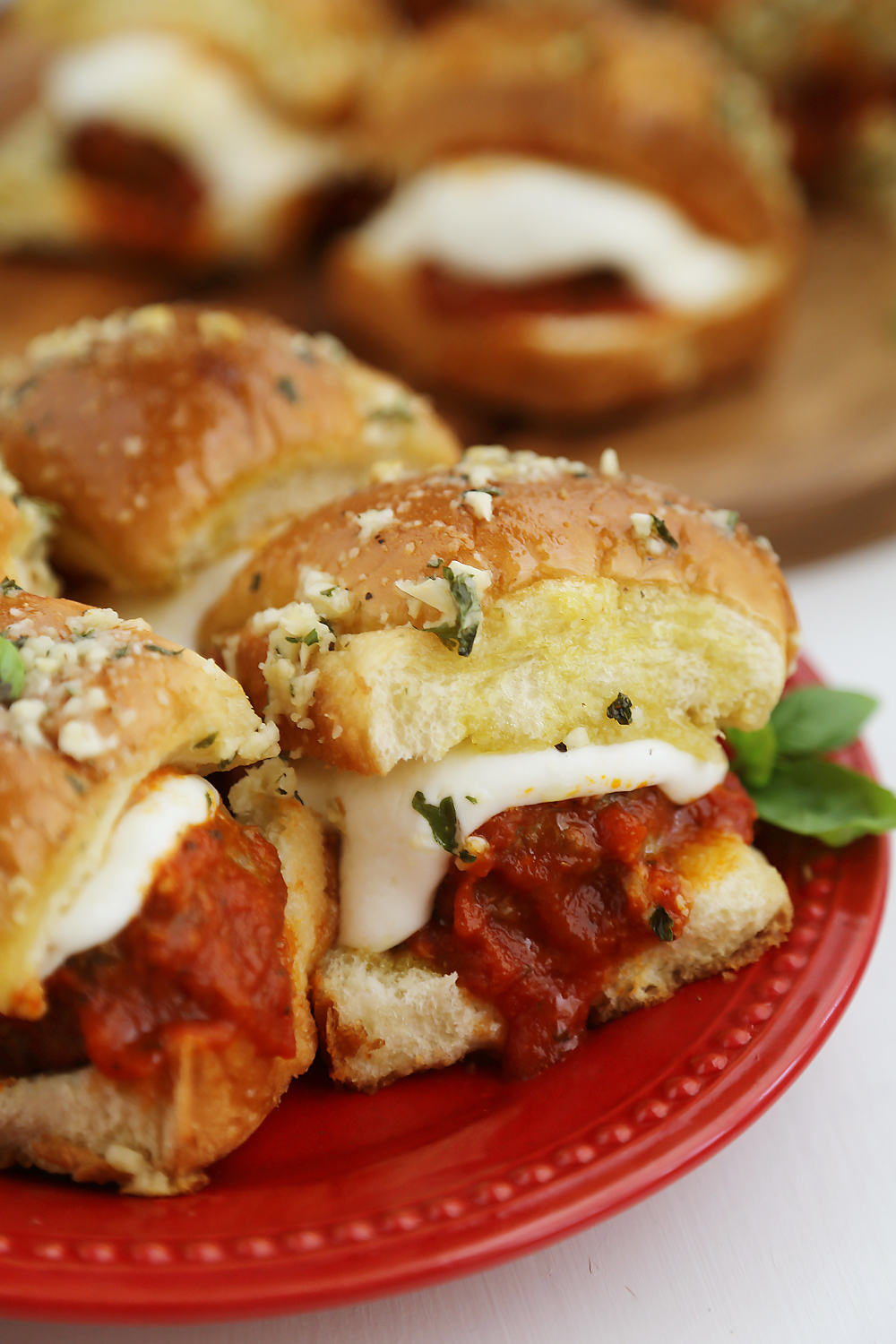 Cheesy Garlic Bread Meatball Sliders - These cheesy, garlic butter mini meatball subs are perfect for parties, snacks and weeknight meals + holidays! Easily homemade! Thecomfortofcooking.com